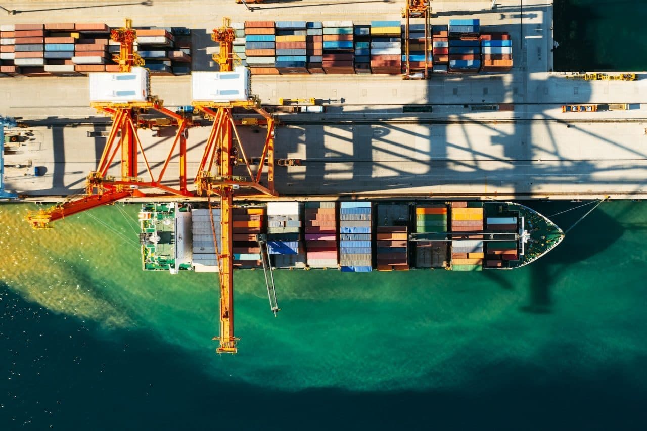 Overhead view of cranes loading containers onto a ship